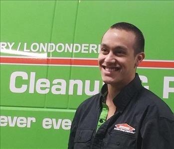 Josh Lyndes standing in front of Servpro truck.